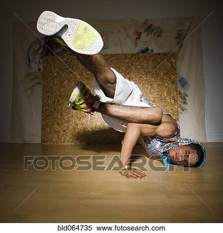 Stock Photography - Hispanic man break dancing in nightclub. Fotosearch