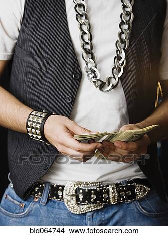 Picture - Hispanic man counting stack of money. Fotosearch