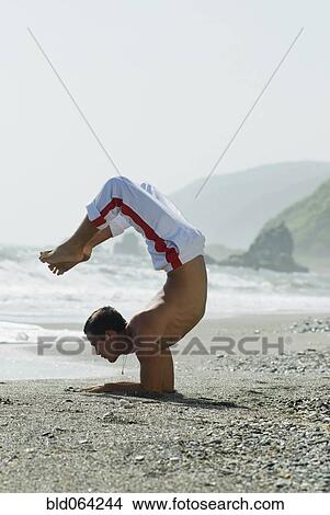 Hispanic man doing yoga at beach View Large Photo Image Picture - Hispanic man doing yoga at beach. Fotosearch