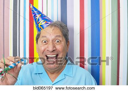 Hispanic man in party hat View Large Photo Image Stock Photo - Hispanic man in party hat. Fotosearch