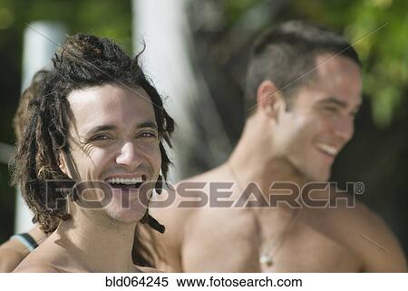 Stock Photography - Hispanic man laughing with friends. Fotosearch