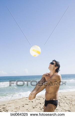 Hispanic man playing volleyball at beach View Large Photo Image Stock Photography - Hispanic man playing volleyball at beach. Fotosearch