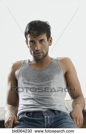 Stock Image - Hispanic man reclining. Fotosearch