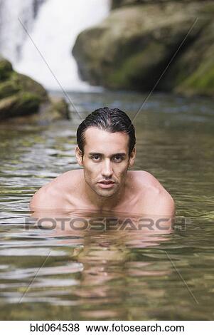 Stock Photo - Hispanic man swimming in stream. Fotosearch