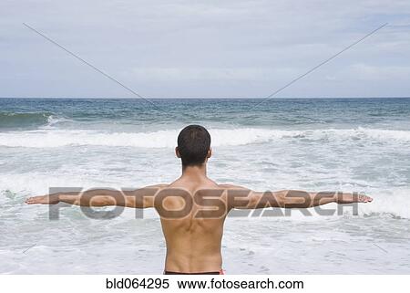Hispanic man with arms out at beach View Large Photo Image Stock Photography - Hispanic man with arms out at beach. Fotosearch
