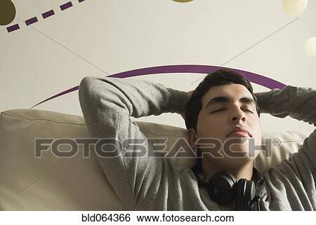 Hispanic man with headphones relaxing View Large Photo Image Stock Photograph - Hispanic man with headphones relaxing. Fotosearch