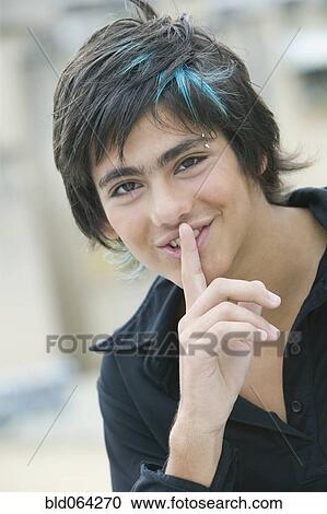 Hispanic teenager making silence motion View Large Photo Image Stock Image - Hispanic teenager making silence motion. Fotosearch