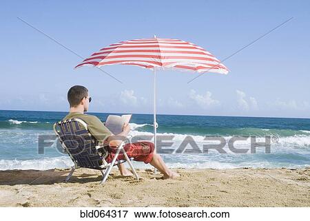 Hispanic teenager relaxing at beach View Large Photo Image Stock Photo - Hispanic teenager relaxing at beach. Fotosearch