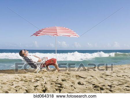 Hispanic teenager relaxing at beach View Large Photo Image Stock Photo - Hispanic teenager relaxing at beach. Fotosearch
