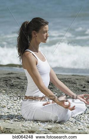 Hispanic woman doing yoga at beach View Large Photo Image Stock Photo - Hispanic woman doing yoga at beach. Fotosearch