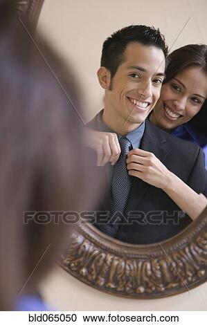 Hispanic woman helping husband with necktie View Large Photo Image Stock Image - Hispanic woman helping husband with necktie. Fotosearch