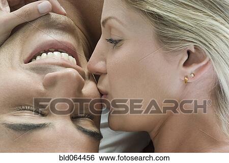 Hispanic woman kissing boyfriend in bed View Large Photo Image Stock Photograph - Hispanic woman kissing boyfriend in bed. Fotosearch