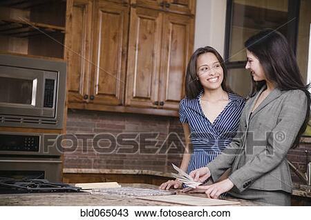 Hispanic woman working with interior designer View Large Photo Image Stock Image - Hispanic woman working with interior designer. Fotosearch
