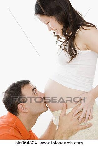 Husband kissing pregnant wife’s stomach View Large Photo Image Picture - Husband kissing pregnant wife’s stomach. Fotosearch