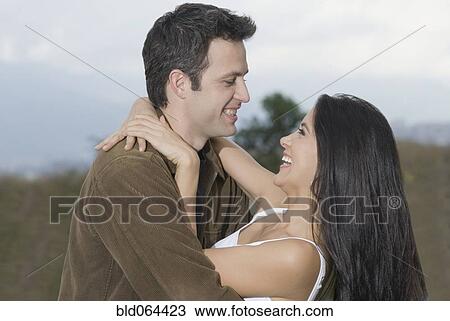 Laughing Hispanic couple hugging View Large Photo Image Stock Image - Laughing Hispanic couple hugging. Fotosearch