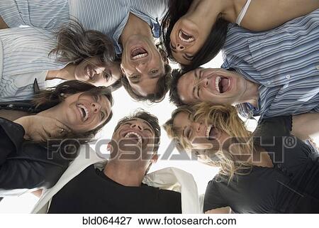 Laughing Hispanic friends hugging View Large Photo Image Stock Photo - Laughing Hispanic friends hugging. Fotosearch