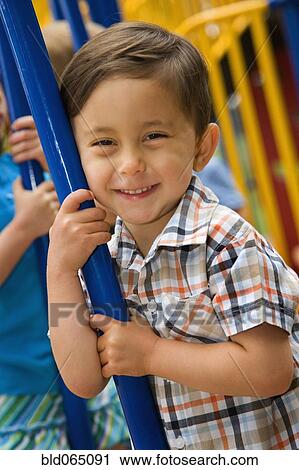 Mixed race boy playing in playground View Large Photo Image Stock Image - Mixed race boy playing in playground. Fotosearch