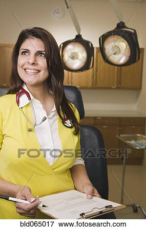 Mixed race doctor in doctor’s office View Large Photo Image Stock Photo - Mixed race doctor in doctor’s office. Fotosearch