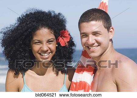 Multi-ethnic couple at beach with umbrella View Large Photo Image Stock Image - Multi-ethnic couple at beach with umbrella. Fotosearch