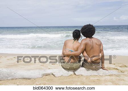 Multi-ethnic couple hugging at beach View Large Photo Image Stock Image - Multi-ethnic couple hugging at beach. Fotosearch