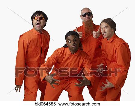 Stock Photography - Multi-ethnic criminals in prison uniforms. Fotosearch