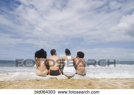 Stock Image - Multi-ethnic friends at beach. Fotosearch