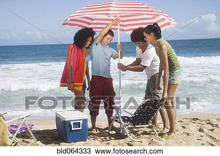 Multi-ethnic friends enjoying the beach View Large Photo Image Stock Image - Multi-ethnic friends enjoying the beach. Fotosearch