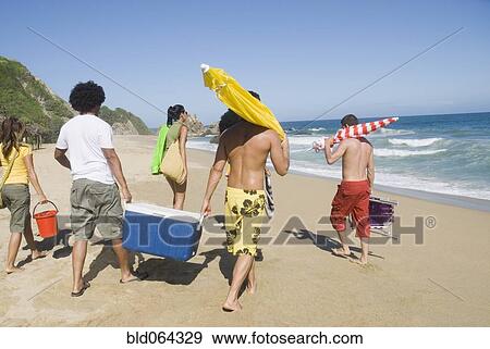 Stock Photo - Multi-ethnic friends enjoying the beach. Fotosearch