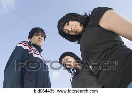Stock Photography - Serious Hispanic friends. Fotosearch