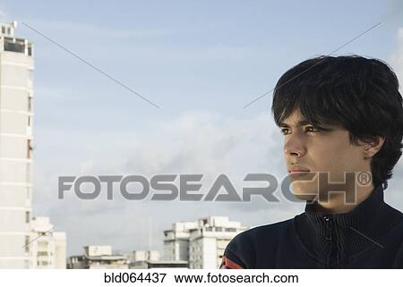 Serious Hispanic man in urban setting View Large Photo Image Stock Photo - Serious Hispanic man in urban setting. Fotosearch