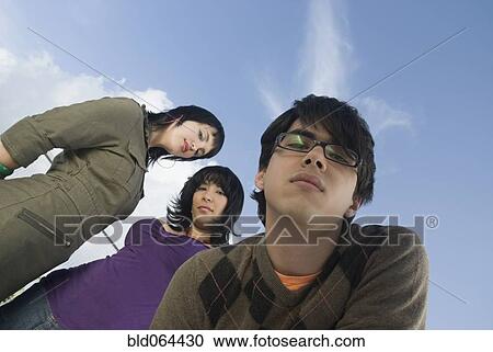 Serious Hispanic man with friends View Large Photo Image Stock Image - Serious Hispanic man with friends. Fotosearch