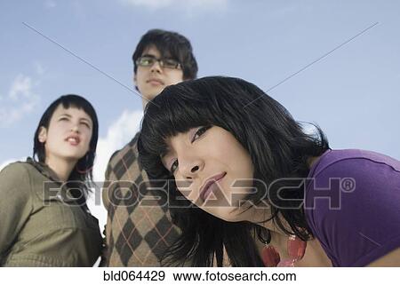 Serious Hispanic woman with friends View Large Photo Image Stock Photo - Serious Hispanic woman with friends. Fotosearch