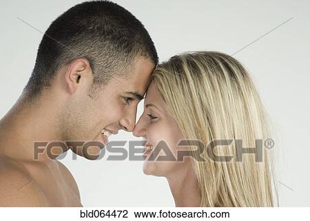 Stock Image - Smiling Hispanic couple face to face. Fotosearch