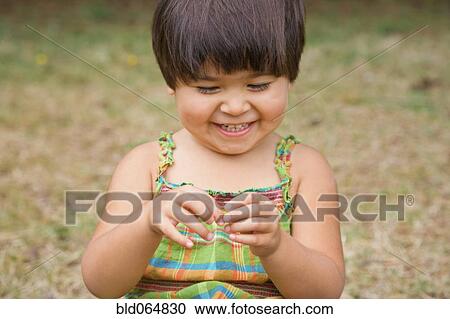 Smiling Mixed race girl playing View Large Photo Image Stock Image - Smiling Mixed race girl playing. Fotosearch
