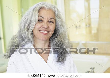 Smiling woman wearing bathrobe in spa View Large Photo Image Stock Image - Smiling woman wearing bathrobe in spa. Fotosearch
