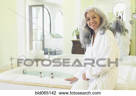 Smiling woman wearing bathrobe in spa View Large Photo Image Stock Image - Smiling woman wearing bathrobe in spa. Fotosearch
