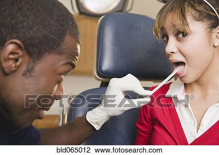 Stock Image - Teenage girl having medical checkup. Fotosearch
