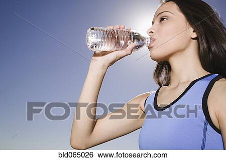 Thirsty Hispanic woman drinking water View Large Photo Image Stock Photograph - Thirsty Hispanic woman drinking water. Fotosearch