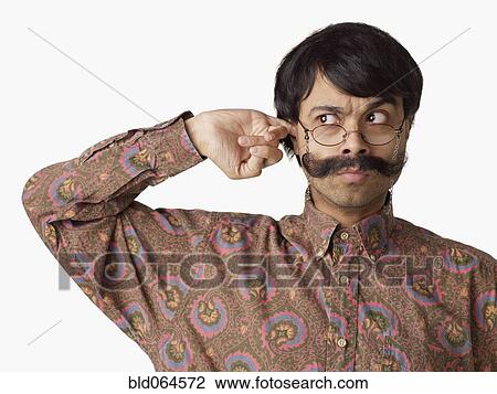 Uncertain Indian man scratching his ear View Large Photo Image Stock Image - Uncertain Indian man scratching his ear. Fotosearch