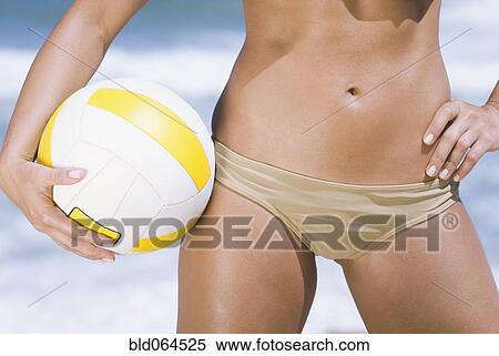 Stock Photography - Volleyball and midsection of Hispanic woman. Fotosearch