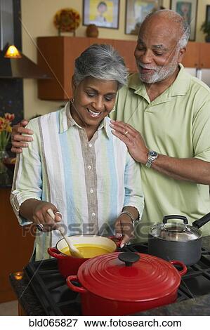 Stock Photo - African couple making dinner. Fotosearch