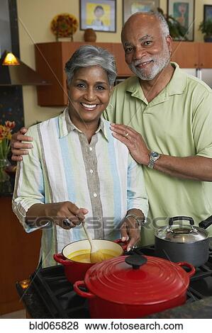 Stock Photo - African couple making dinner. Fotosearch