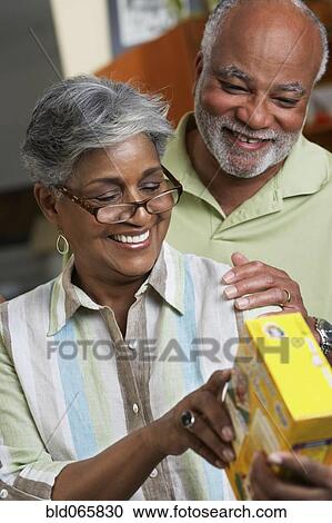 African couple reading food ingredients View Large Photo Image Stock Image - African couple reading food ingredients. Fotosearch
