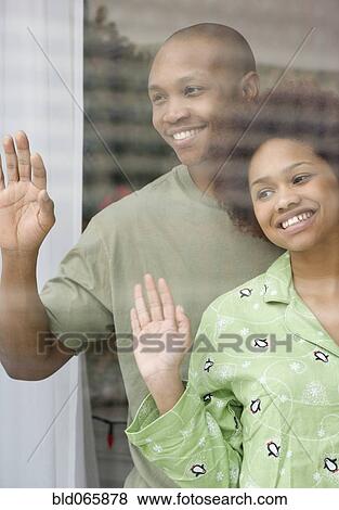 Stock Photo - African couple waving in pajamas. Fotosearch