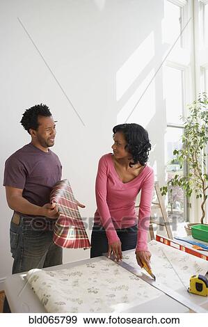 African man asking wife about bold wallpaper View Large Photo Image Stock Photo - African man asking wife about bold wallpaper. Fotosearch
