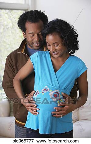 African man caressing pregnant wife’s stomach View Large Photo Image Stock Photo - African man caressing pregnant wife’s stomach. Fotosearch