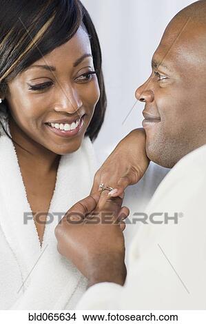 African man giving girlfriend engagement ring View Large Photo Image Picture - African man giving girlfriend engagement ring. Fotosearch