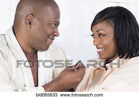 African man giving girlfriend engagement ring View Large Photo Image Stock Image - African man giving girlfriend engagement ring. Fotosearch