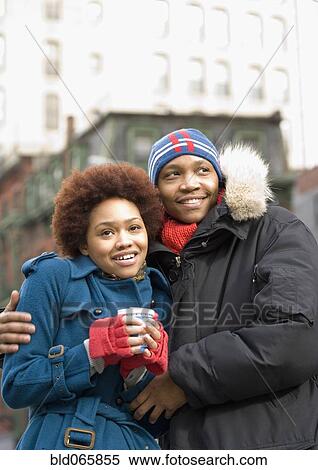 Stock Photography - African man hugging girlfriend. Fotosearch