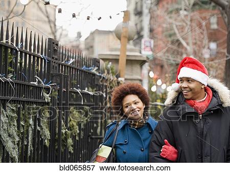 African man in santa hat walking outdoors with girlfriend View Large Photo Image Stock Photo - African man in santa hat walking outdoors with girlfriend. Fotosearch